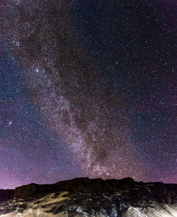 Scenic view of mountains against sky at night