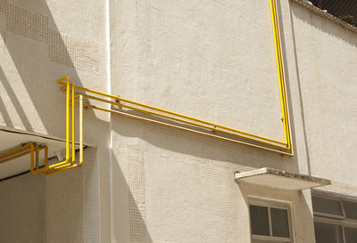 Low angle view of yellow pipe gas building