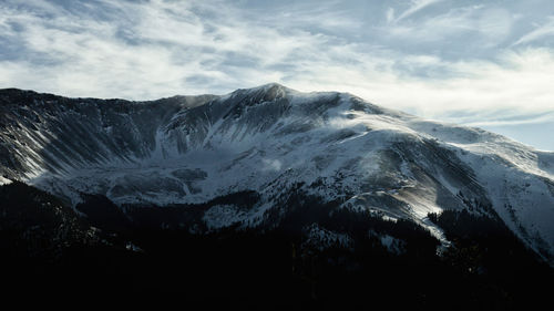 Wide angle of snow blowing across mountains near winterpark