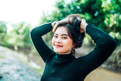 Portrait of young woman standing outdoors