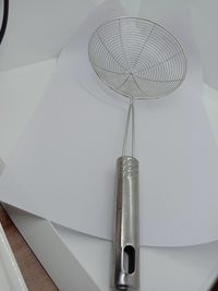 High angle view of pen on table against white wall
