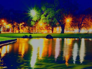 Scenic view of lake against sky at night