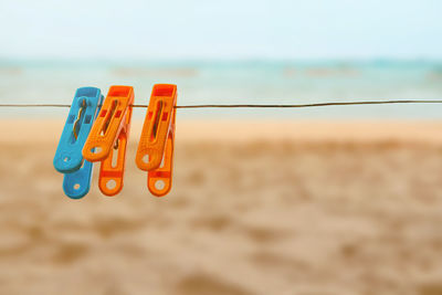 Close-up of clothespins hanging on rope