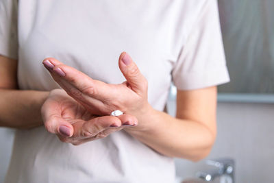 Midsection of couple holding hands