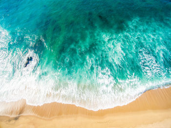 High angle view of waves on beach