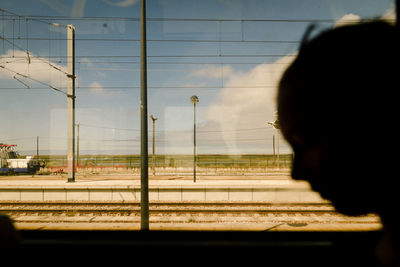 Portrait of man looking through train window