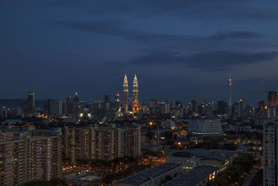 Illuminated cityscape against sky at night