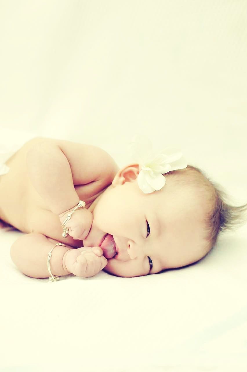 indoors, studio shot, white background, childhood, person, close-up, lifestyles, baby, holding, copy space, home interior, leisure activity, babyhood, new life, beginnings, freshness