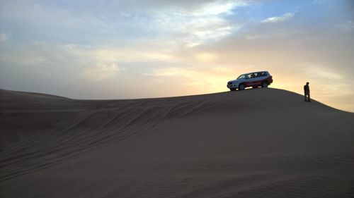 People on landscape at sunset