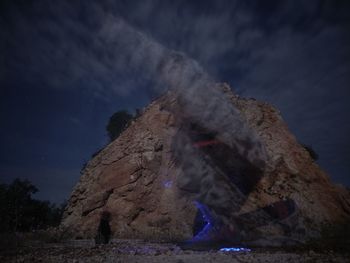 Low angle view of rock formation against sky