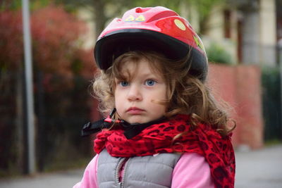 Cute girl wearing helmet looking away