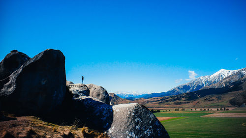 Scenic view of mountains against clear blue sky