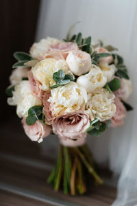 Midsection of bride holding bouquet