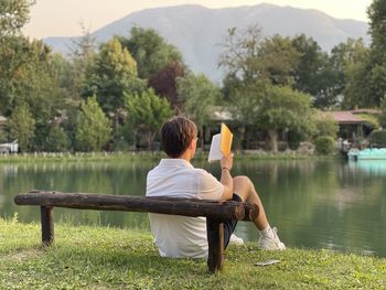 Rear view of woman exercising in park