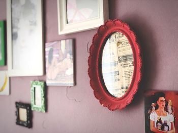 Close-up of electric lamp on table against wall