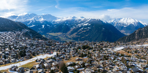 High angle view of townscape and mountains against sky