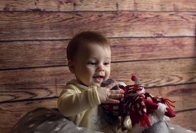 Portrait of cute girl sitting on wood