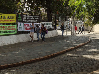 People walking on street in city