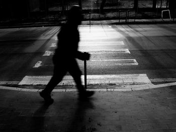 Shadow of man walking on street
