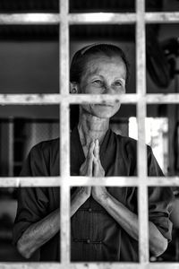 Smiling senior woman standing at window