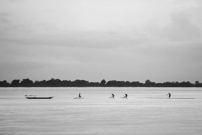 Fisherman fishing in river against sky