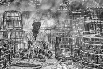 Senior man making wicker baskets