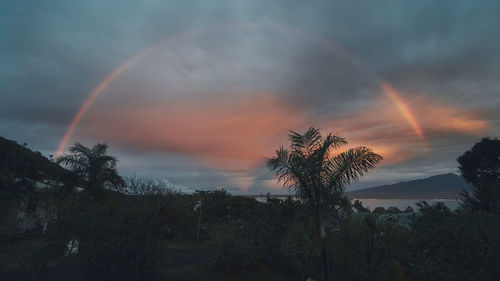 Scenic view of rainbow against sky at sunset