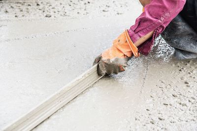 Construction man working with cement floor finishing