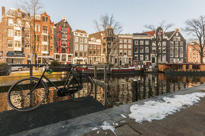 Bicycle parked in city during winter