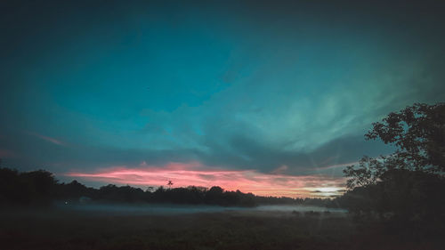 Scenic view of silhouette landscape against sky during sunset