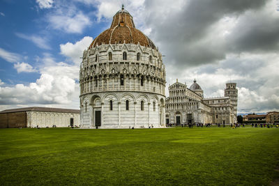 Pisa, italy, view of cathedral and tower against cloudy sky