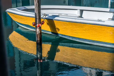 High angle view of yellow boat moored in harbor