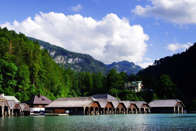 Scenic view of lake and buildings against sky