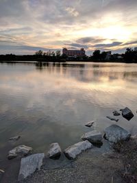 Scenic view of lake against sky at sunset