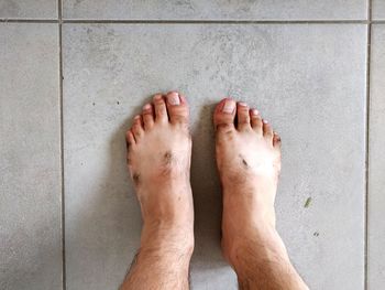 Low section of man standing on floor