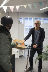 Bicycle courier delivering parcel