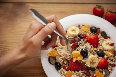 Cropped image of person having breakfast served on table