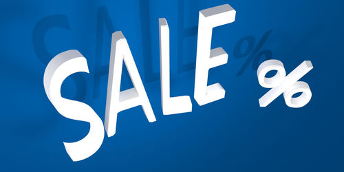 Close-up of information sign against blue background