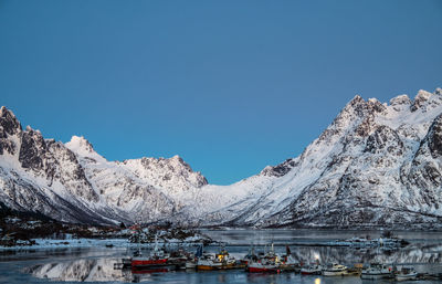 Scenic view of snowcapped mountains against clear blue sky