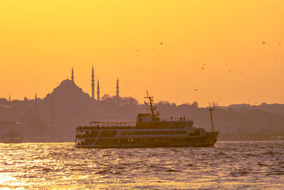 Ferry and suleymaniye mosque at sunset.