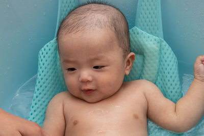 Cute baby boy looking away