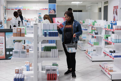 Rear view of woman standing in store