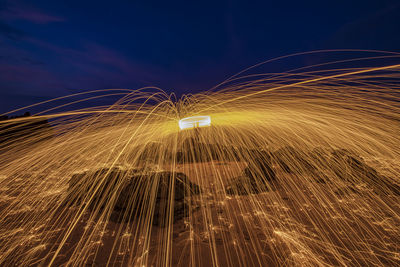 Low angle view of light trails at night