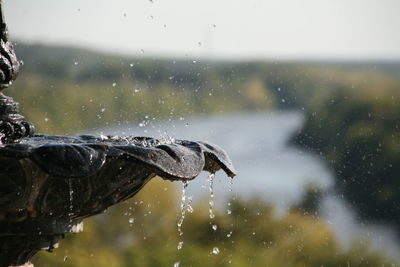 Close-up of raindrops on glass window during rainy season