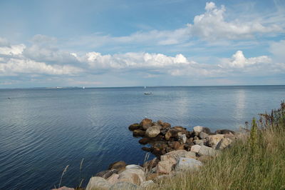 Scenic view of sea against cloudy sky