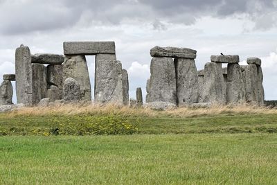 Old ruins on field against sky