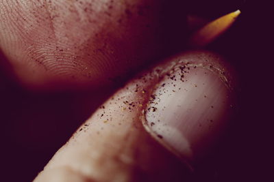 Close-up of dirt on thumb