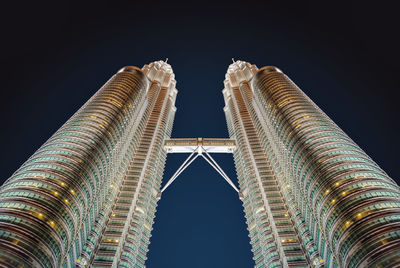 Low angle view of buildings against sky at night