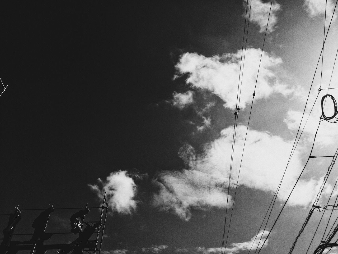 LOW ANGLE VIEW OF CABLES AGAINST CLOUDY SKY