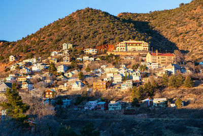 Houses by town against sky